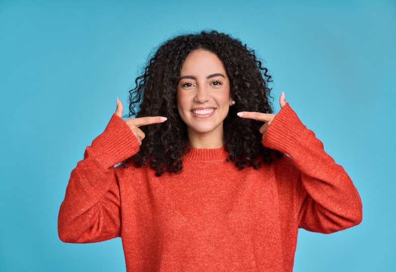 Woman smiling confidently after getting dental veneers in New Lenox and Mokena, IL